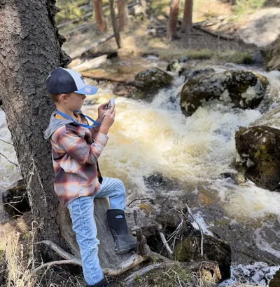 One of Jordan's sons photographing a mountain creek